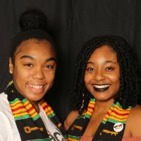 two friends smiling at GradFest photo booth